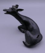 An 18th/19th century Chinese patinated bronze model of a deer. 11 cm long.
