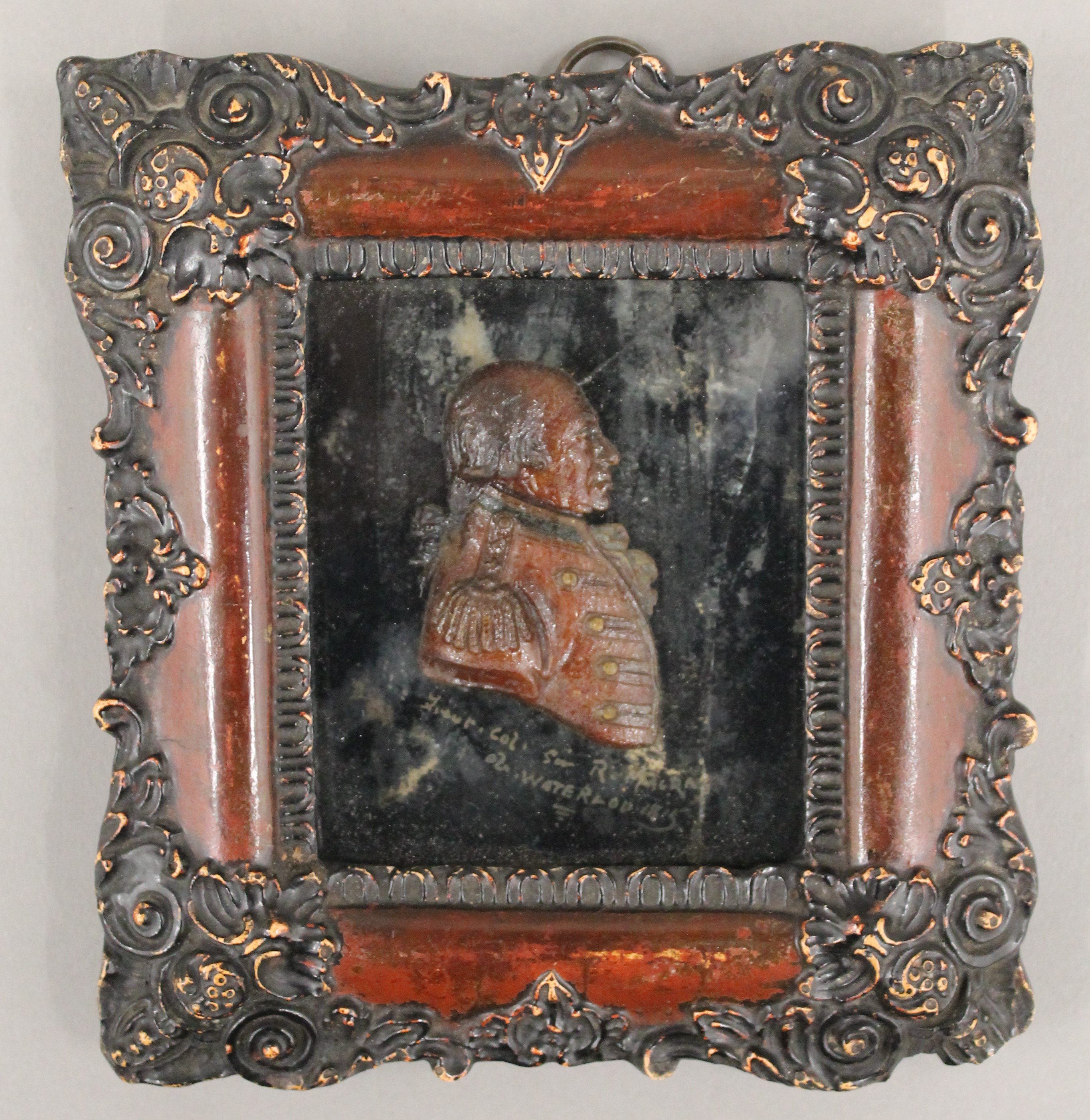 A small 19th century wax portrait of a military officer, framed and glazed. 16 x 17.5 cm.