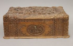 An Eastern carved wooden box. 33.5 cm wide.