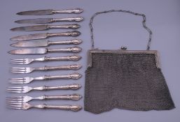 A vintage mesh handbag and a quantity of silver handled cutlery.