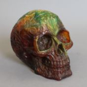 A model of a skull. 13 cm high.