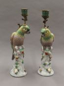 A pair of porcelain candlesticks formed as parrots. 36 cm high.