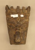 An African tribal carved wooden mask. 36 cm long.