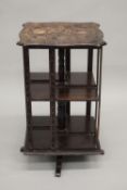 A small Victorian carved revolving bookcase. 60 cm high.