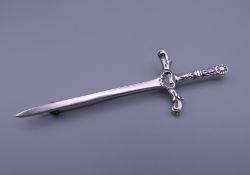 A silver kilt pin formed as a sword. 8.5 cm long.
