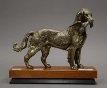 An early 20th century silvered pewter sculpture of a hunting dog with a pheasant,