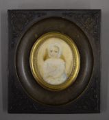 A 19th century miniature portrait on ivory of an infant in vulcanite frame. 9.5 x 10.5 cm overall.