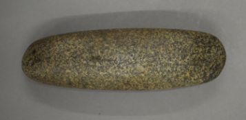 A stone hand axe, possibly Neolithic. 16 cm long.