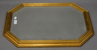 A gilt framed bevelled wall glass. 49 x 70 cm.