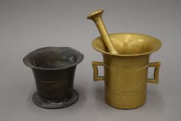 Two antique bronze mortars and a pestle. The largest 12.5 cm high.