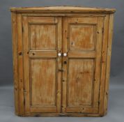 A Georgian pine corner cupboard. 111 cm wide.