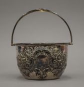 An embossed silver sugar bowl. 10.5 cm wide. 125.8 grammes.