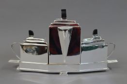 An Art Deco style silver plated tea set. 36 cm wide.