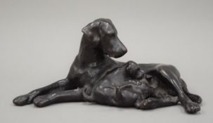 A patinated bronze model of a pointer and puppies. 31 cm wide.