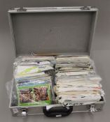 A flight case containing a large number of postcards, many in postcard fair packers.