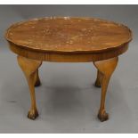 A small walnut coffee table. 69 cm long.