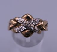 A 9 ct gold puzzle ring. Ring size O. 4.6 grammes.