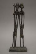 A cast bronze model of two African tribes people. 30.5 cm high.