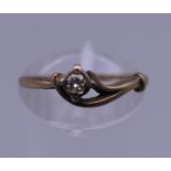 A 9 ct gold diamond solitaire ring. Ring size M. 1.3 grammes total weight.