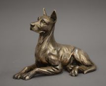 A silver clad model of a dog. 17 cm long.