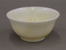 A Chinese turned speckled stone bowl. 10 cm diameter.