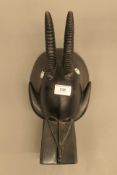 An African tribal carved wooden mask. 35.5 cm long.