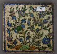 A 19th century floral Qajar pottery tile. 24 cm wide.