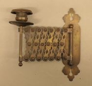 An antique extending brass candle sconce. 37 cm long fully extended.