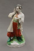 A porcelain figure of a Russian man. 24 cm high.