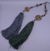 Two Chinese jade mounted tassels. Each approximately 45 cm long.