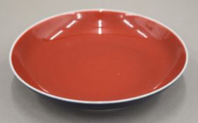 A Chinese porcelain blue and red ground dish, the underside with six character seal mark.
