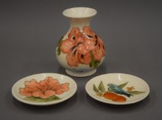 A Moorcroft vase and two small Moorcroft dishes. The former 13 cm high.