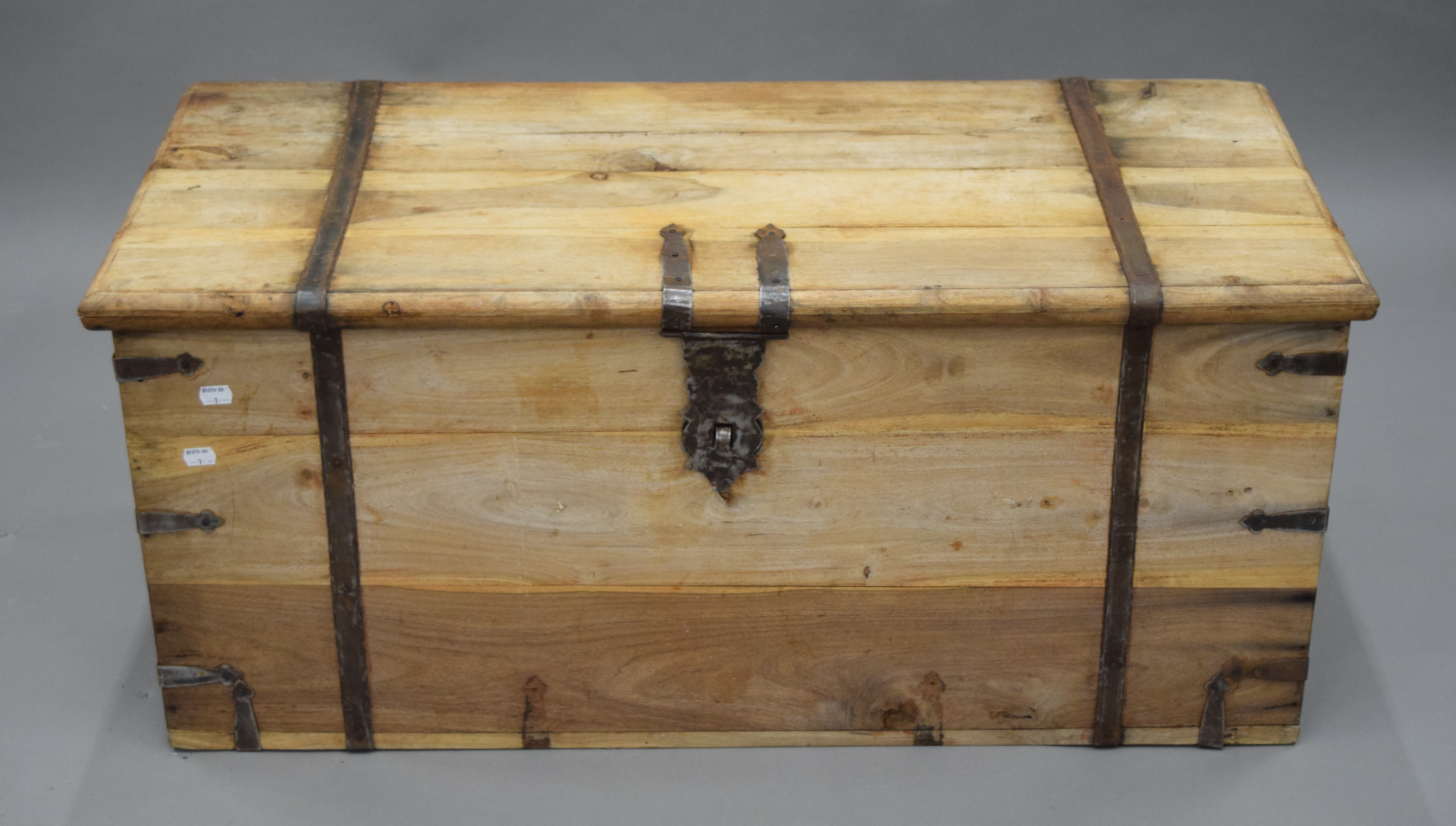 A 19th century striped teak trunk with iron strap work. 100 cm wide.