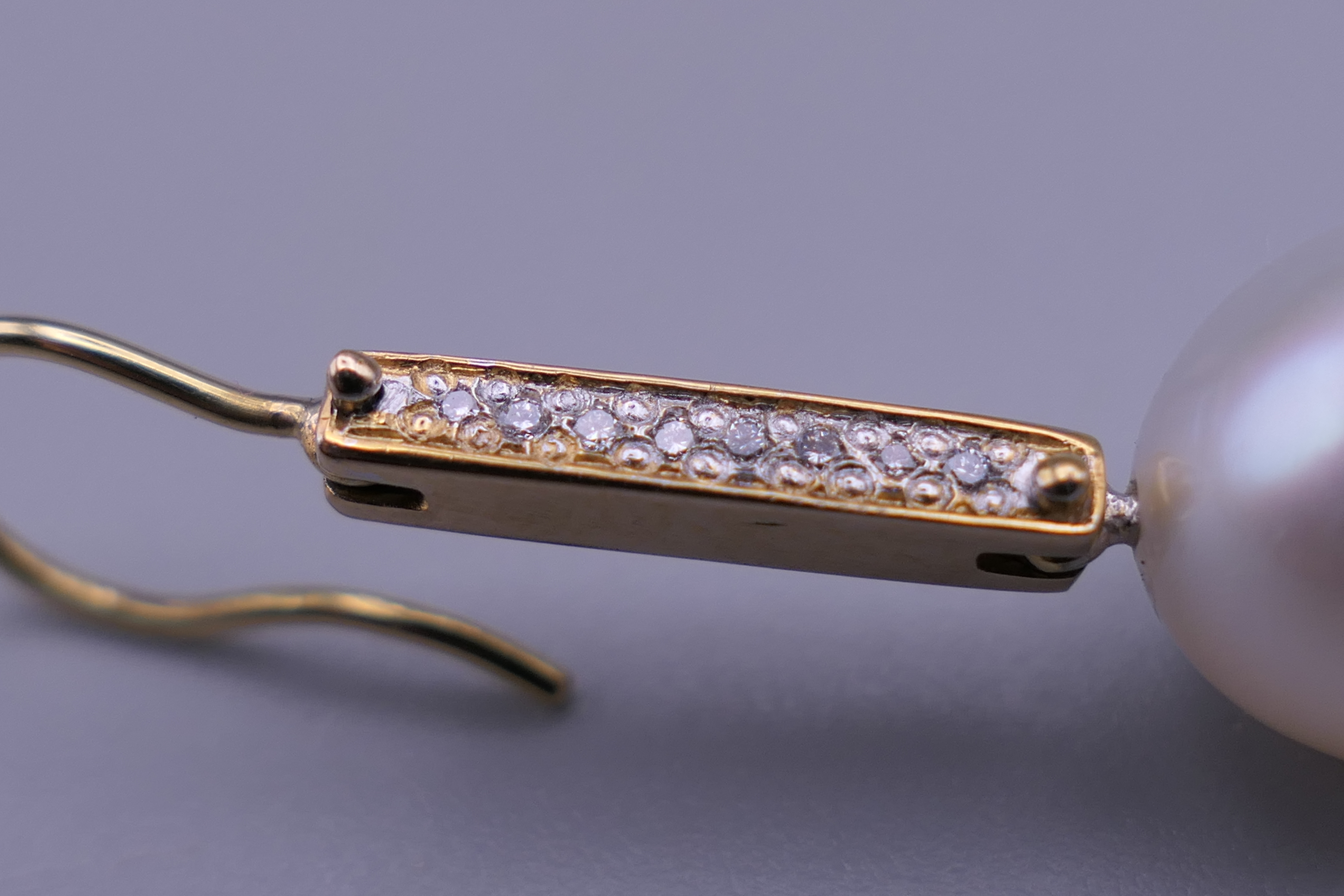 A pair of unmarked 18 K gold diamond and pearl earrings. 3.25 cm high. - Image 3 of 5