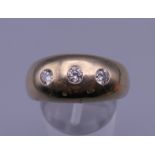 A 9 ct gold gypsy set diamond ring. Ring size V. 11.1 grammes total weight.