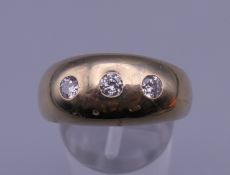 A 9 ct gold gypsy set diamond ring. Ring size V. 11.1 grammes total weight.