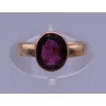 A garnet set gold ring, possibly 9 ct and 18 ct gold. Ring size F. 1.9 grammes total weight.