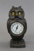 A bronze owl form clock. 17 cm high.