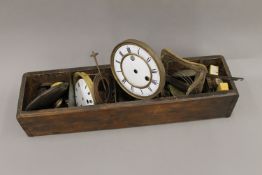 A vintage pine engineer's divided box containing a quantity of clock parts, including springs,