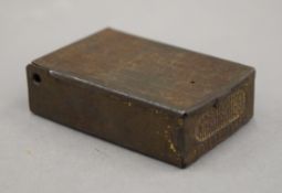 A tin vesta with matches and a candle holder, marked Comet, possibly WWI. 5.5 cm wide.