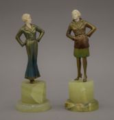 A pair of Art Deco ivory and painted bronze figurines, each mounted on an onyx plinth base.