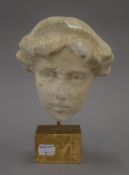 A carved marble bust of a lady mounted on a painted wooden display stand. 21.5 cm high overall.