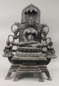 A large bronze shrine centred with Buddha. 75 cm high.