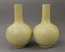 A pair of Chinese yellow ground vases, the undersides drilled. 27 cm high.