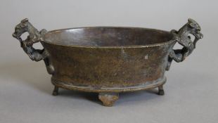 A Chinese patinated bronze censer. 20 cm wide.