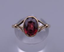 A 9 ct gold and garnet ring. Ring size Q. 1.7 grammes total weight.