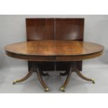 A 19th century style mahogany two leaf twin pillar dining table. 304 cm long with leaves in.