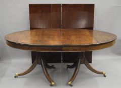 A 19th century style mahogany two leaf twin pillar dining table. 304 cm long with leaves in.