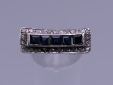 A 18 ct white gold diamond and sapphire cocktail ring. Ring size L. 5.6 grammes total weight.