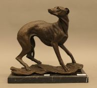 After J B MENE, a large bronze model of a greyhound, mounted on a marble base. 34 cm long.